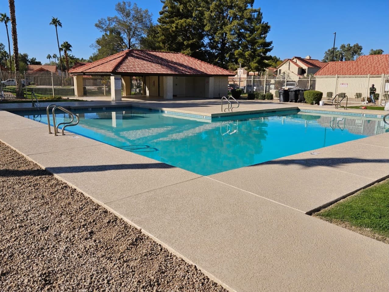 A restored pool deck surrounding an Arizona backyard pool