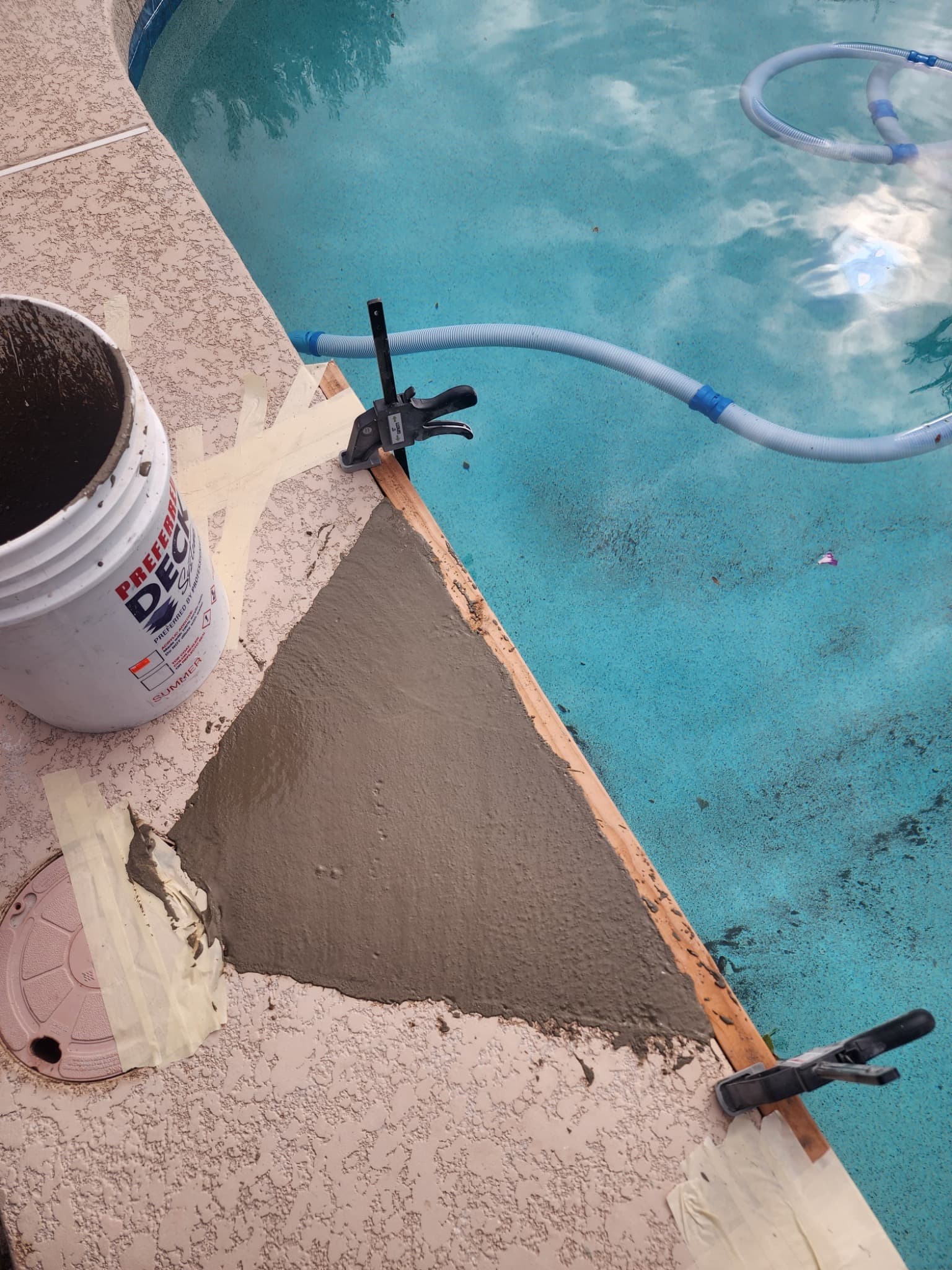 Concrete rebuilt around the pool skimmer